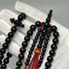 Tijani Tasbih in Yusr Khor 10 mm – Black Coral with Red String | Kourous Handmade