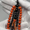 Détail des perles Marjane orange teinté avec ficelle orange, chapelet Tijani fait main